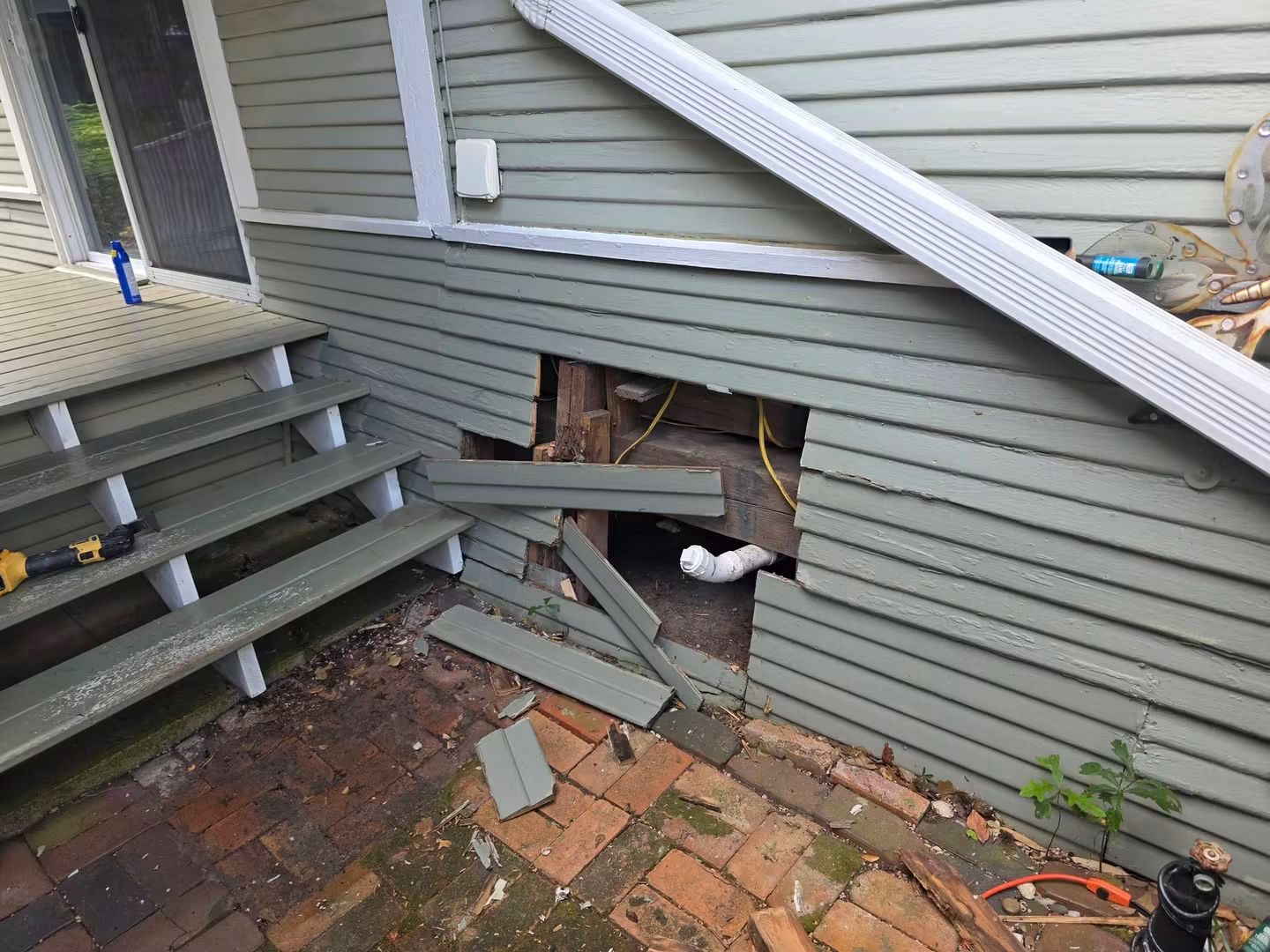Exterior siding opened to address deteriorated wood near the deck