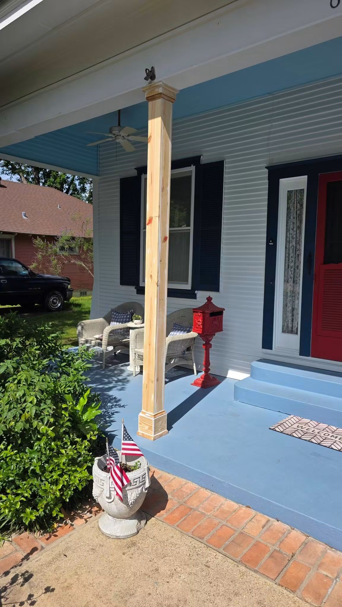 Unpainted custom porch column wrap with built-out trim, plinth base, and layered crown detail