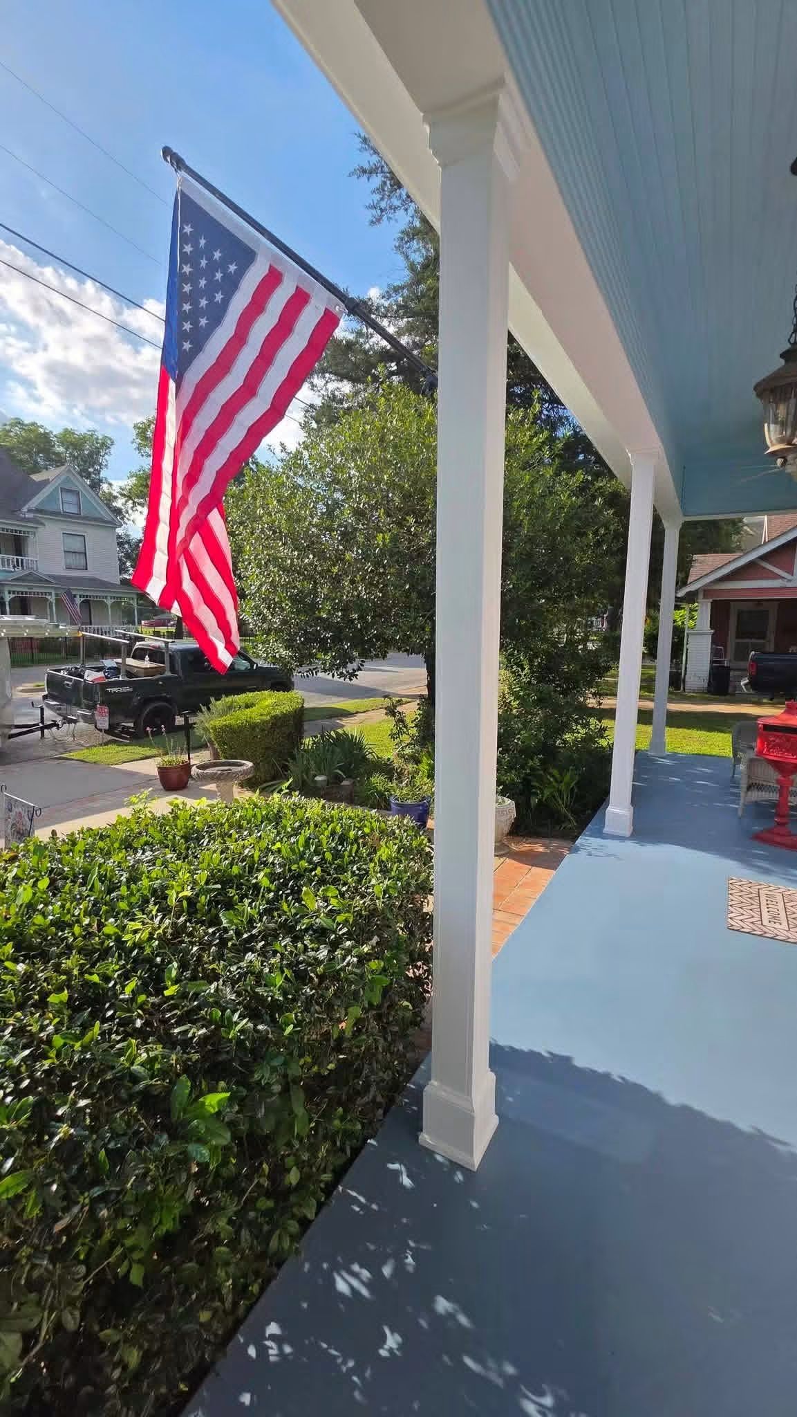 Finished historic historic porch with painted custom column wraps along the full porch