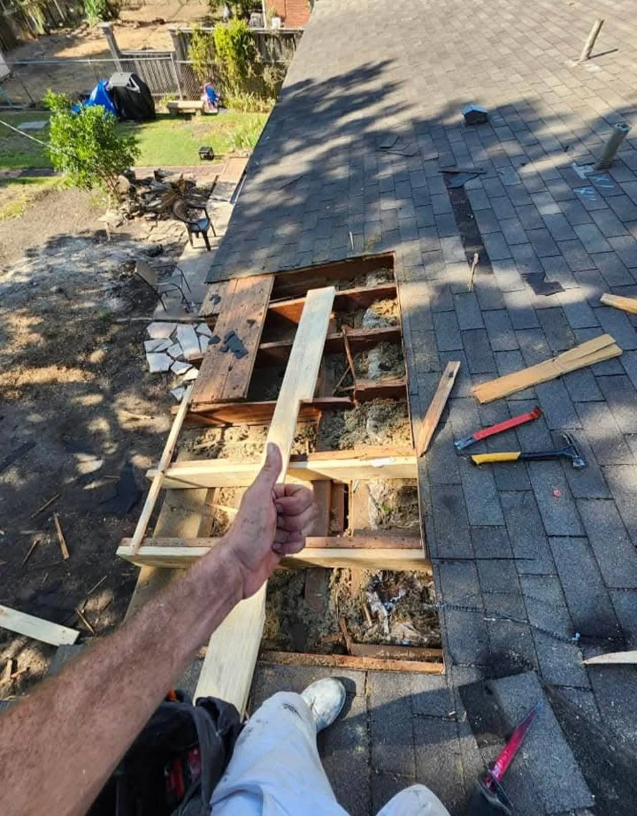 Open roof cavity viewed from above during rafter replacement at the home