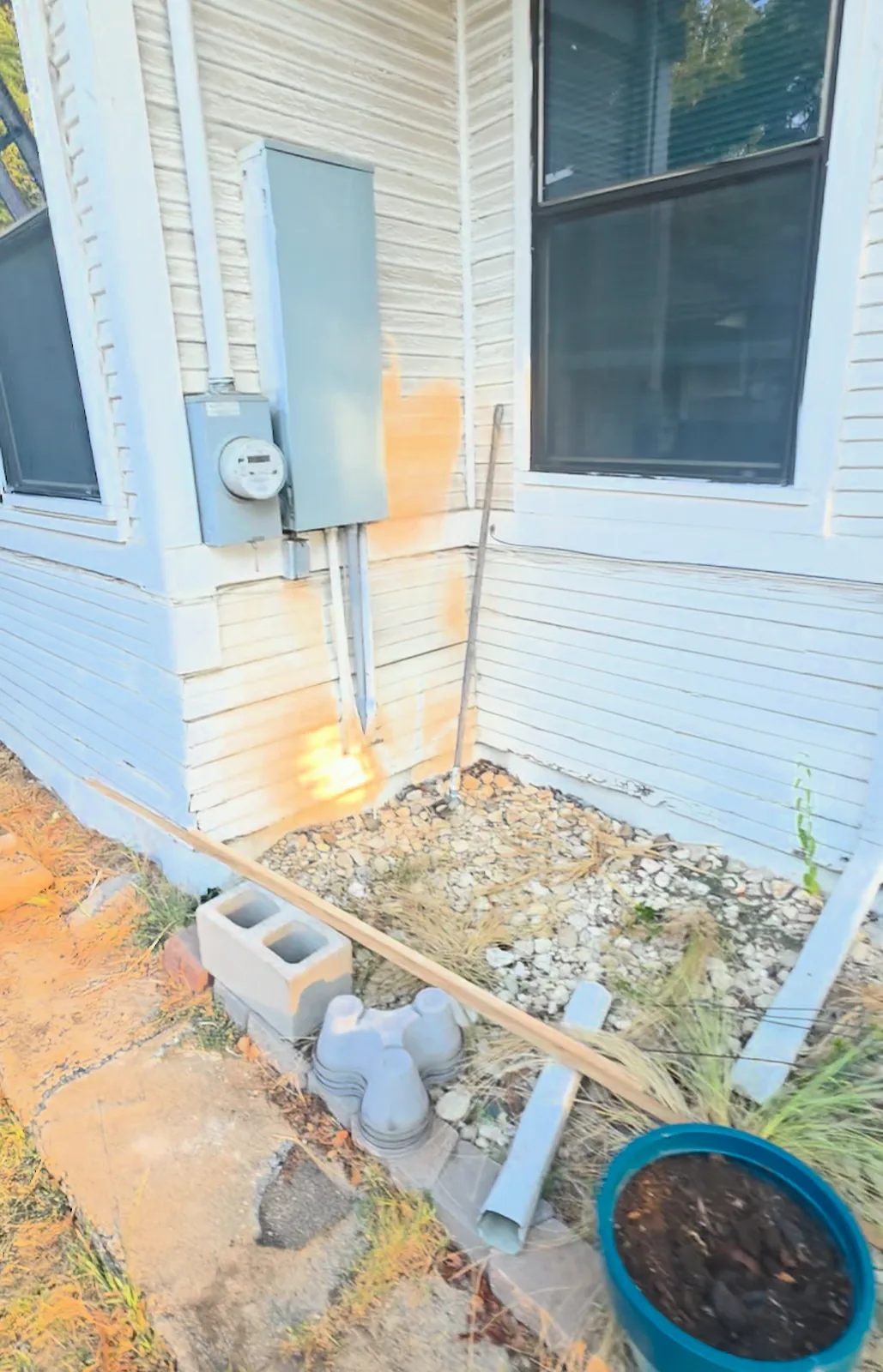 Original bottom boards at the meter corner before replacement