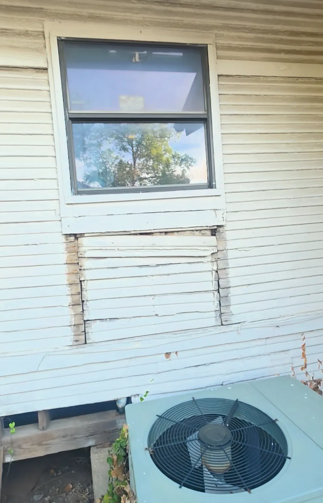 Patched-in section below a window where a larger window used to be