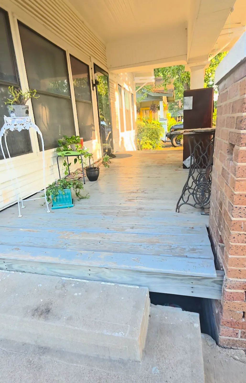 Worn covered porch deck before sanding and refinishing