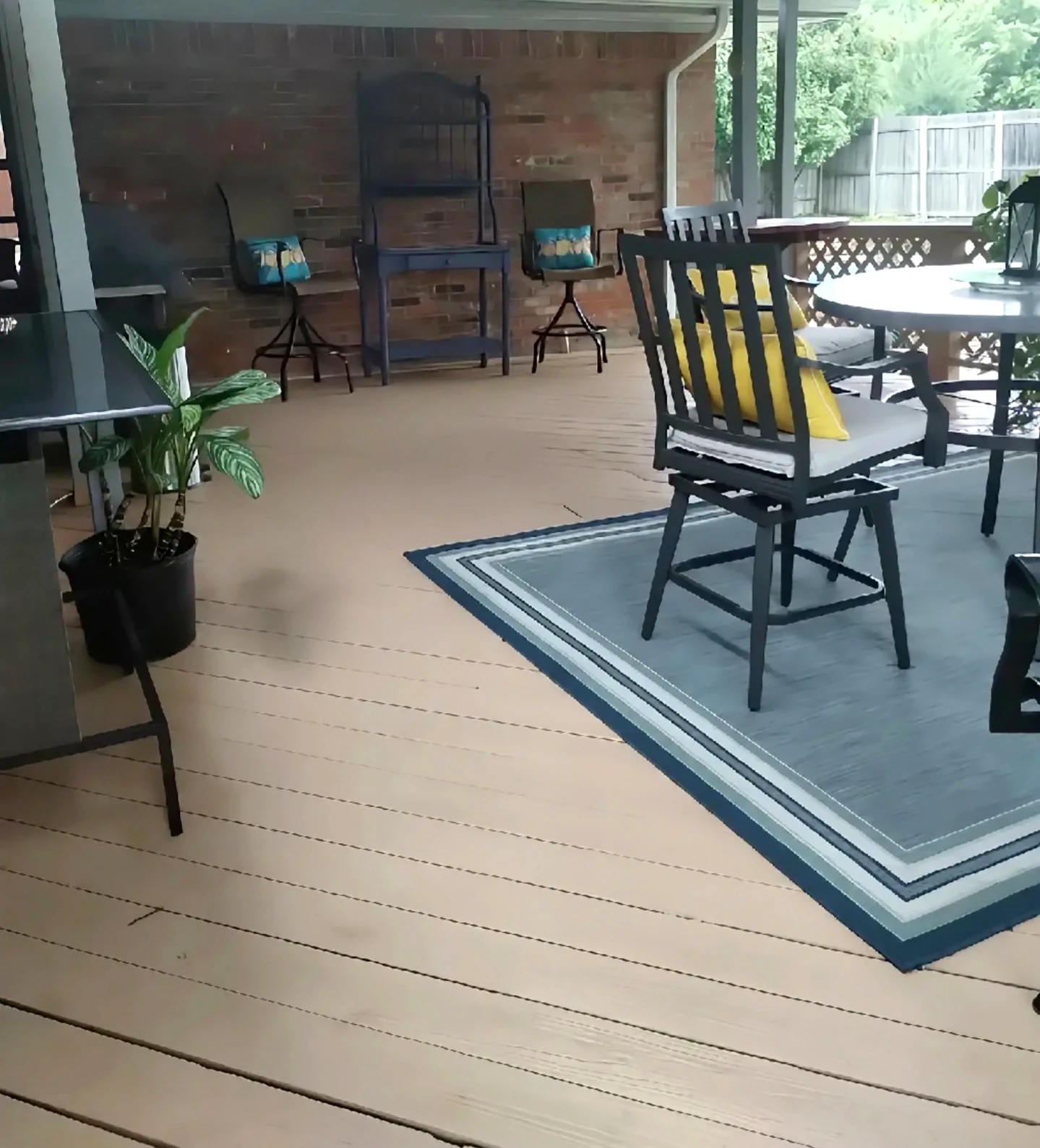 Alternate finished covered deck view showing the refinished floorboards beside the dining area