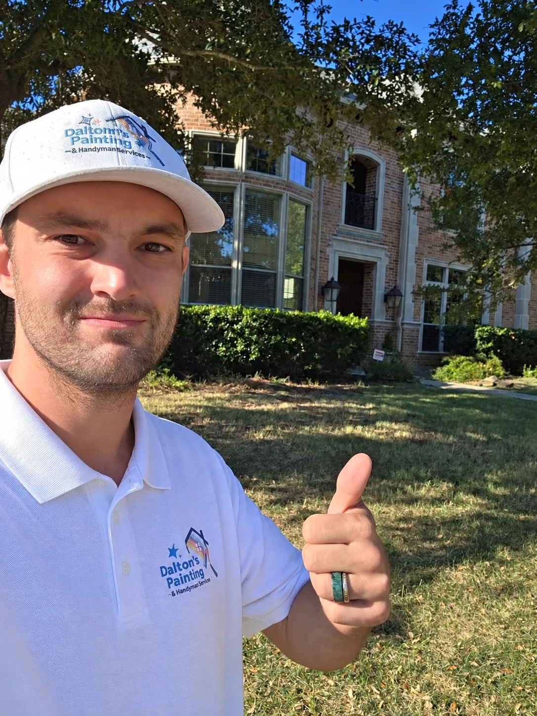 Daltonn Huffines wearing Daltonn’s Painting and Handyman Services branded workwear in front of a home