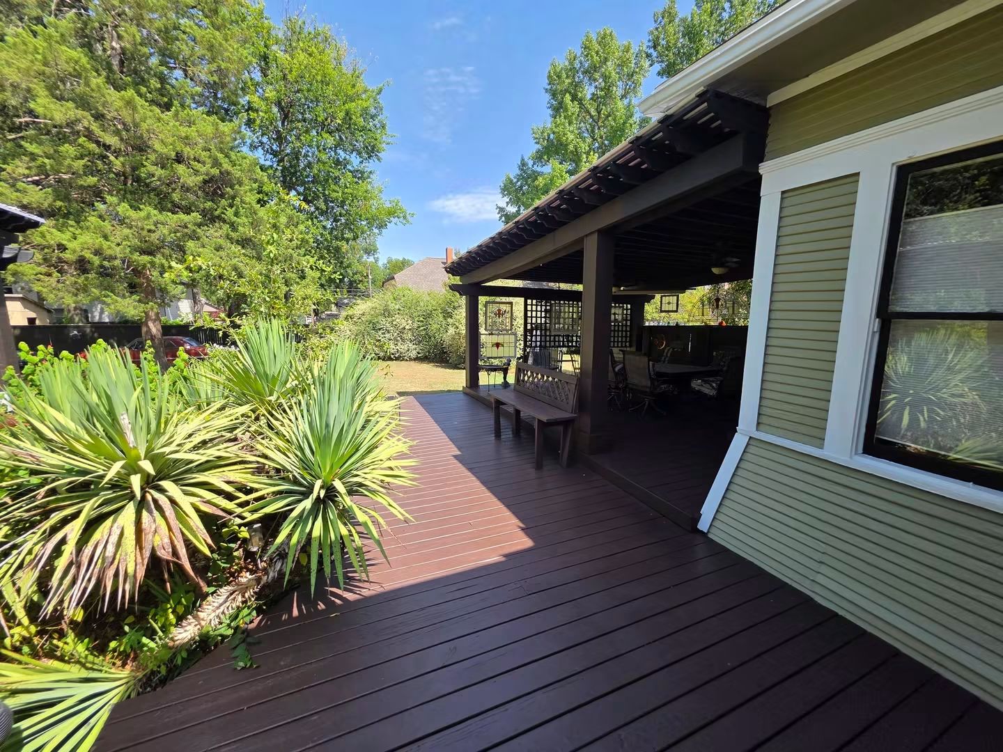 Finished stained deck along the side of a historic home