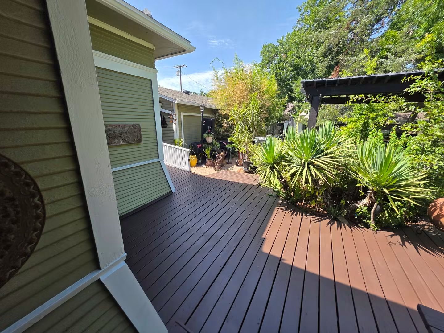 Finished stained deck walkway beside the historic Terrell home