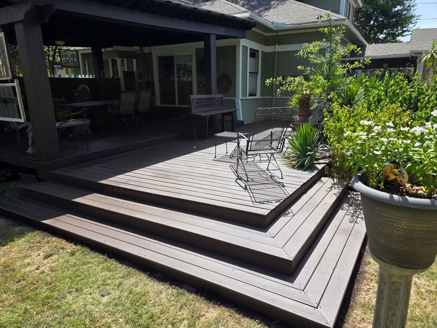 Finished historic deck from the matching front camera angle with repaired steps and a uniform solid-color stain