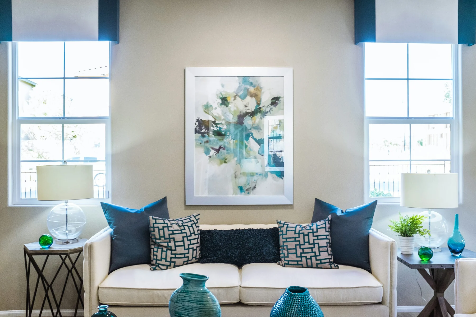 Elegant bright living room with softly painted neutral walls and blue accents
