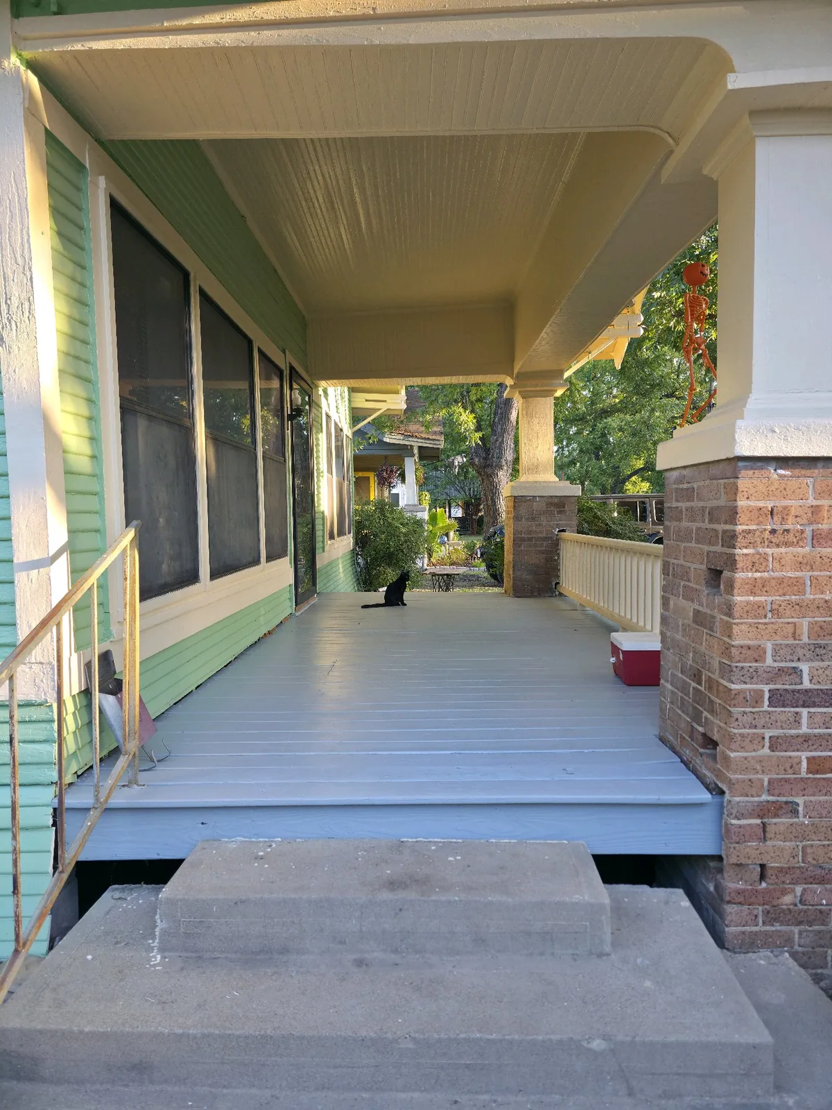 Finished covered porch deck after sanding and Sherwin-Williams Forté