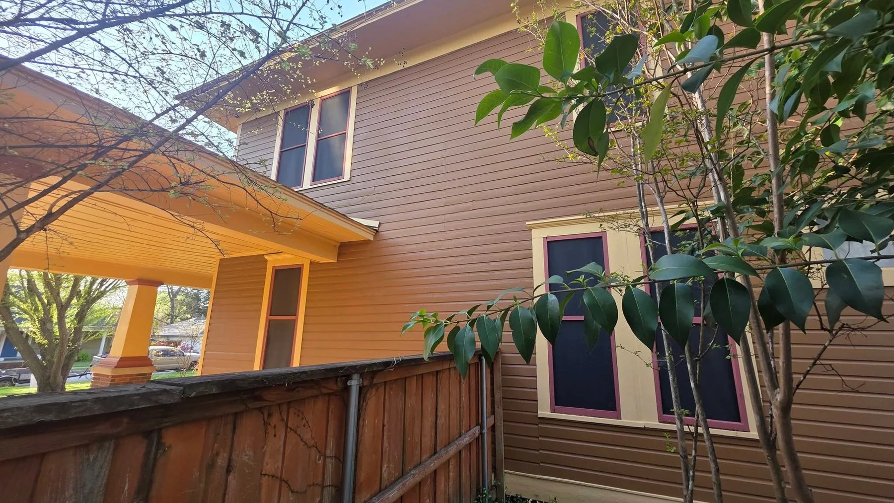 Finished side elevation with restored siding, windows, and trim