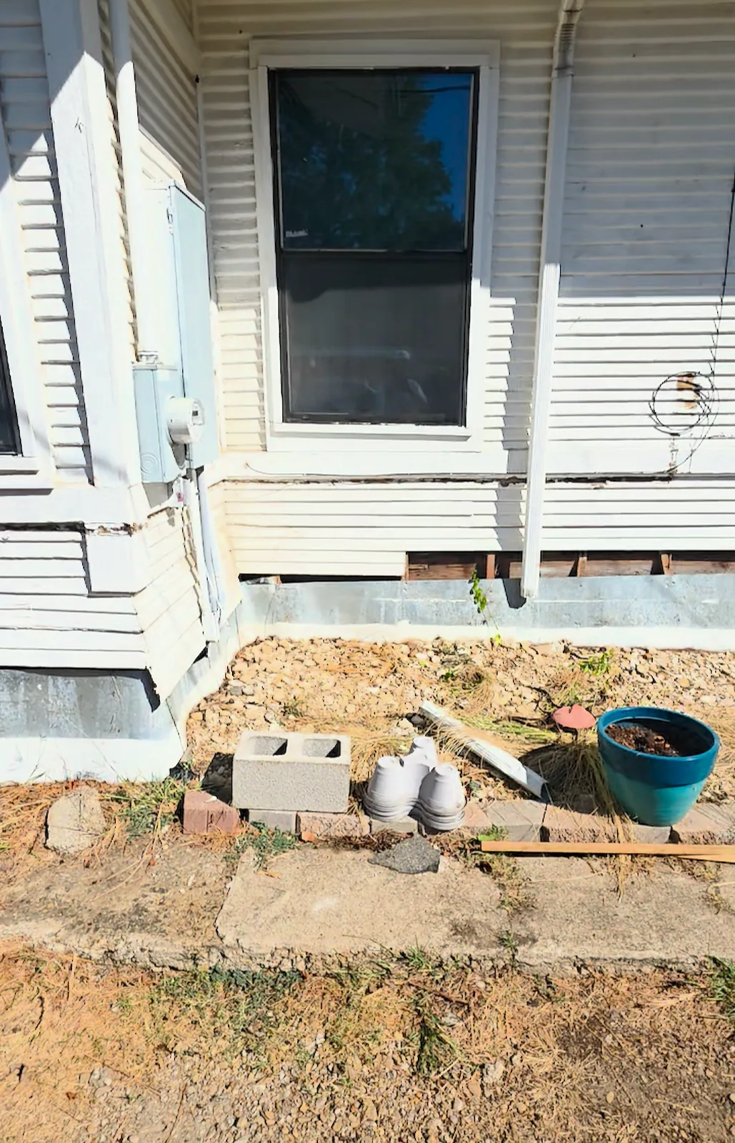 Bottom boards removed along the side of the house during repairs