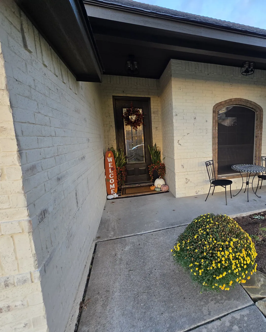 Front door and porch after the brick was limewashed cream