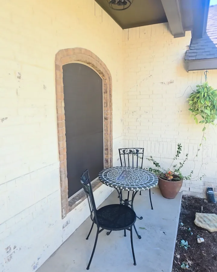 Porch window and bistro table after limewash