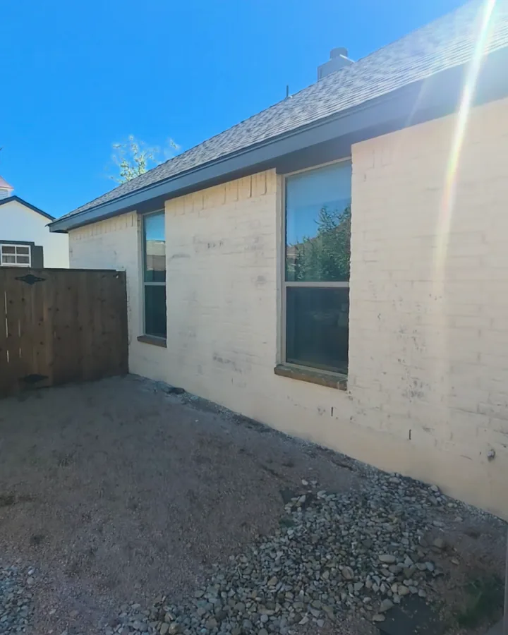 Side wall of the house after the brick was limewashed cream