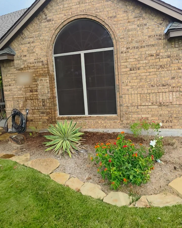 Arched front window on the original tan and brown brick, before limewash