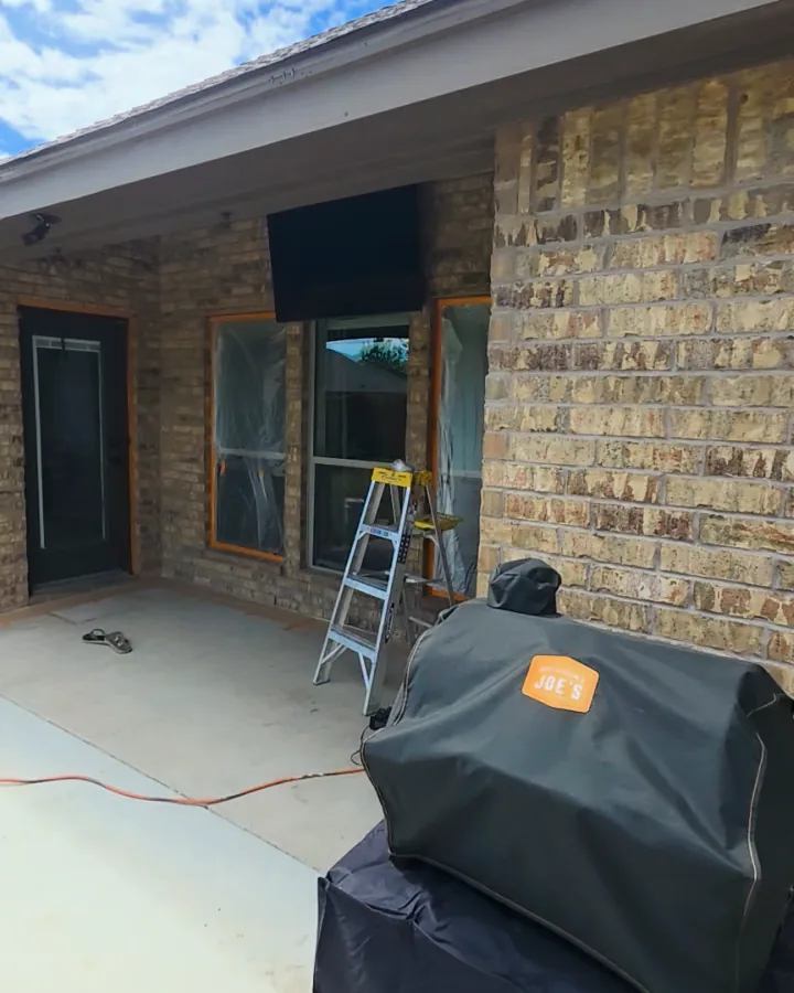 Covered back patio with the original brick before limewash