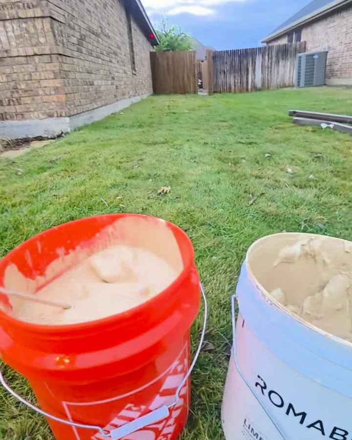 Buckets of Romabio Classico Limewash mixed and ready on the lawn