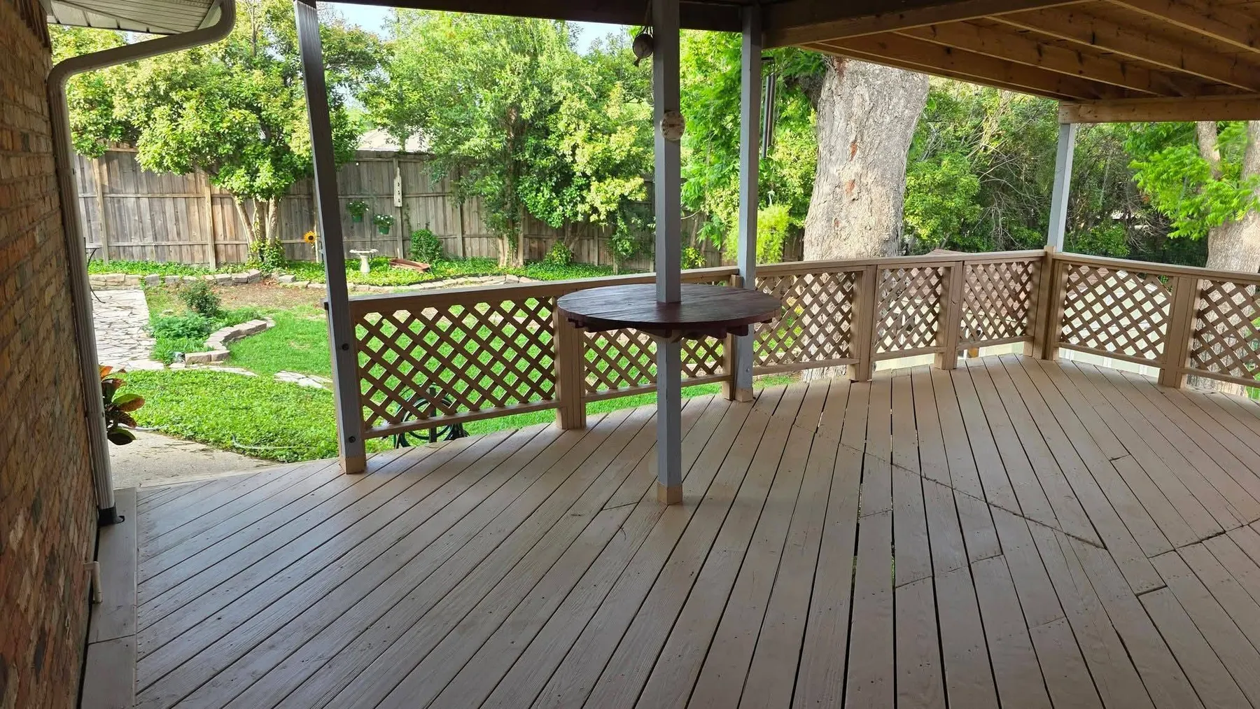 Completed covered deck shown unfurnished with finished floor and lattice railing