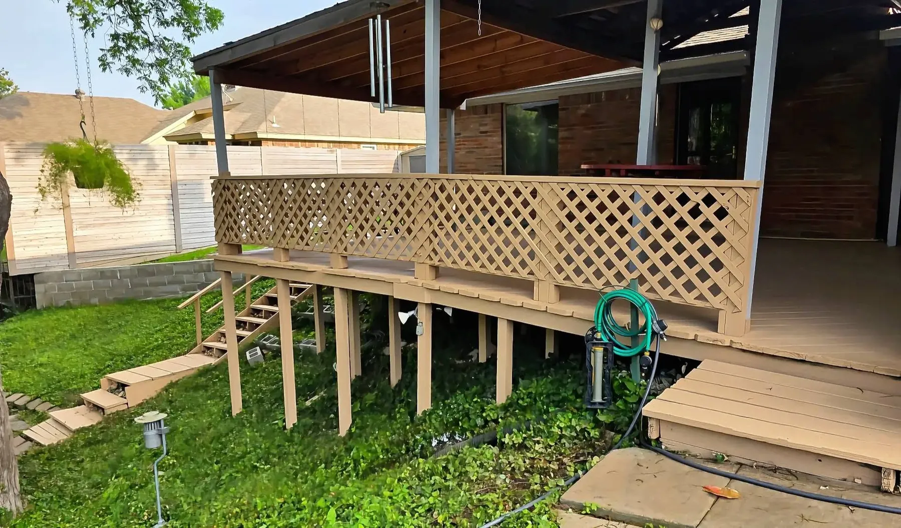 Exterior of the completed elevated covered deck and lattice railing before furnishing