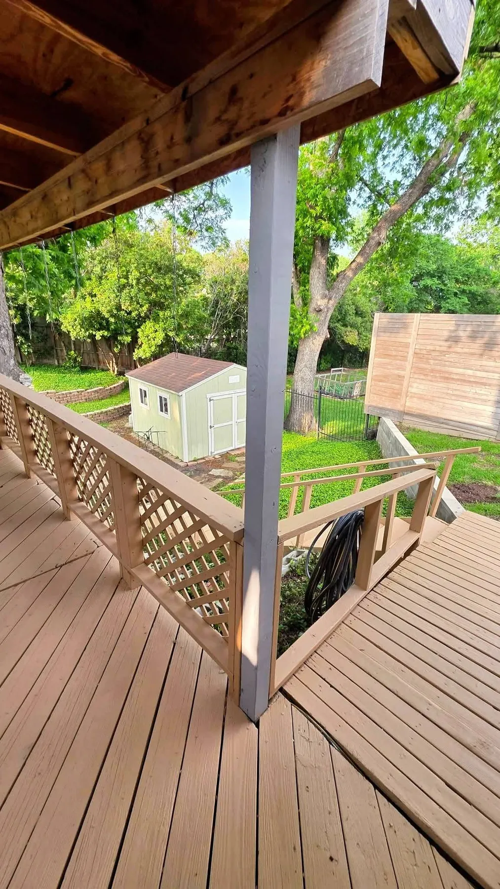 Finished deck boards and lattice railing at the covered patio