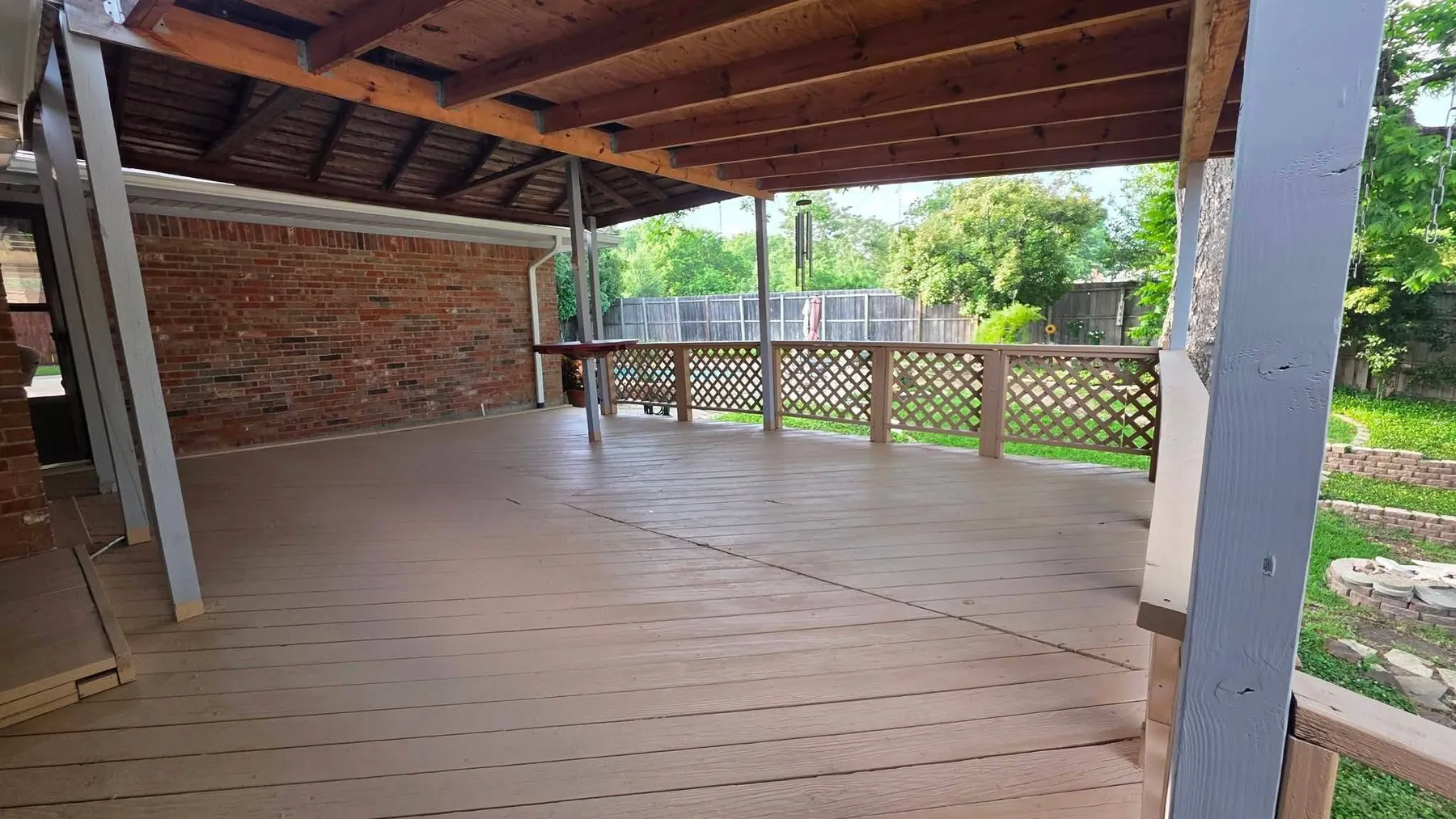 Completed covered deck floor and railing while the patio is still unfurnished