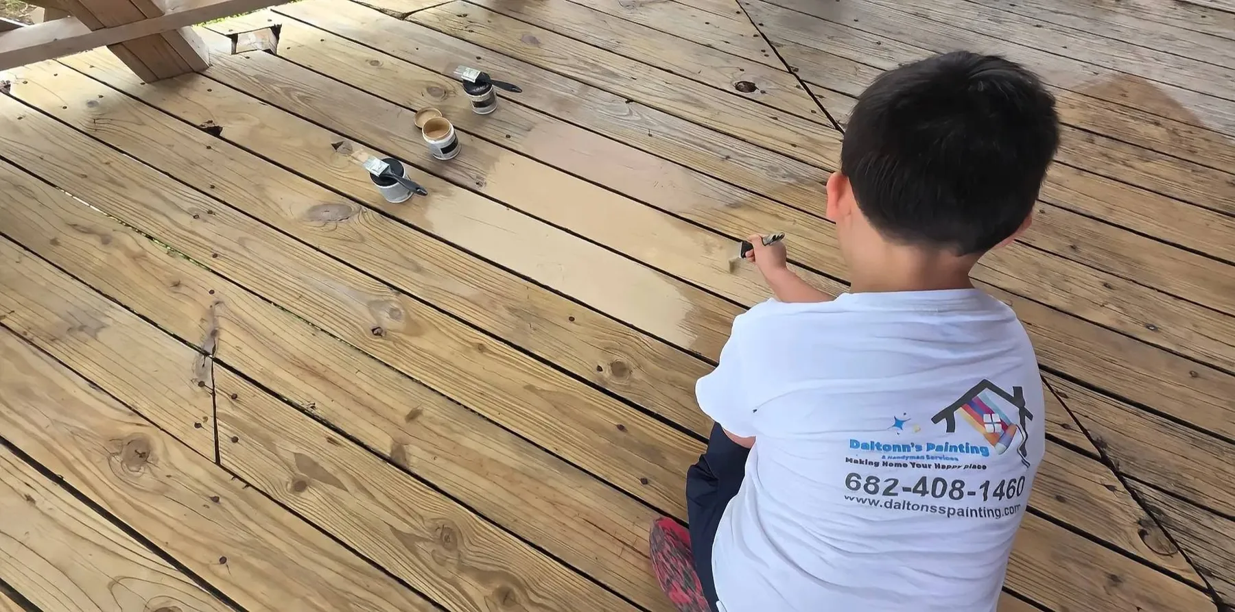 Alexander, Daltonn’s son, testing finish samples directly on the deck boards