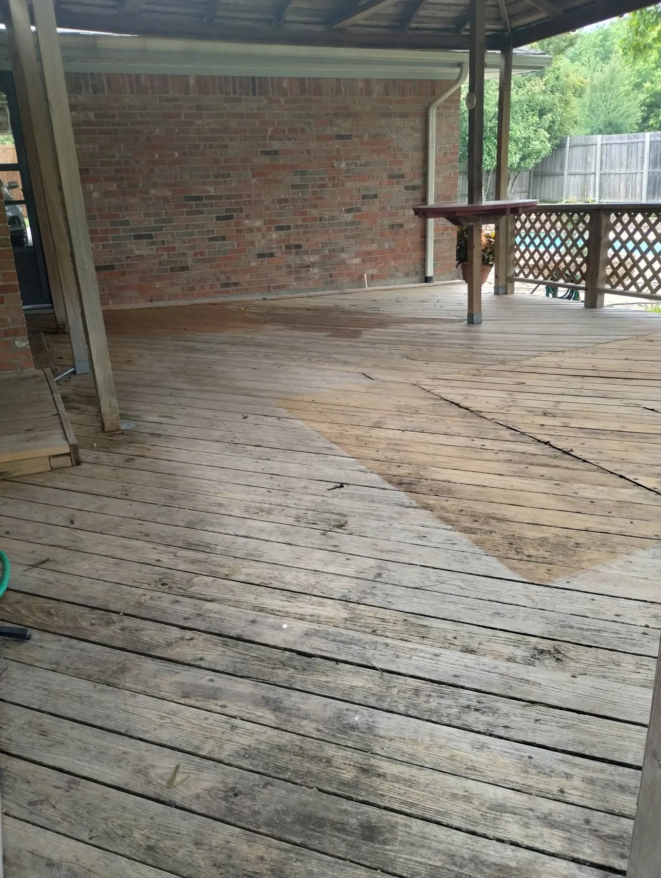 Weathered deck floorboards before refinishing