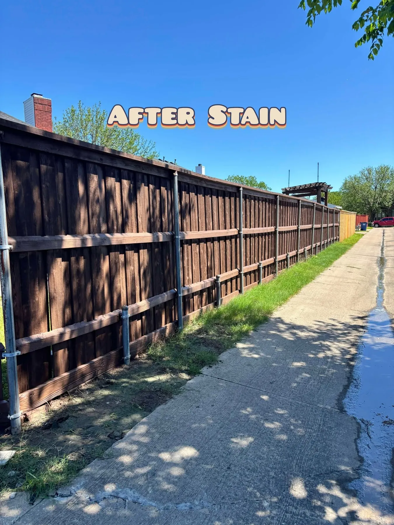 Long alley-side privacy fence after staining