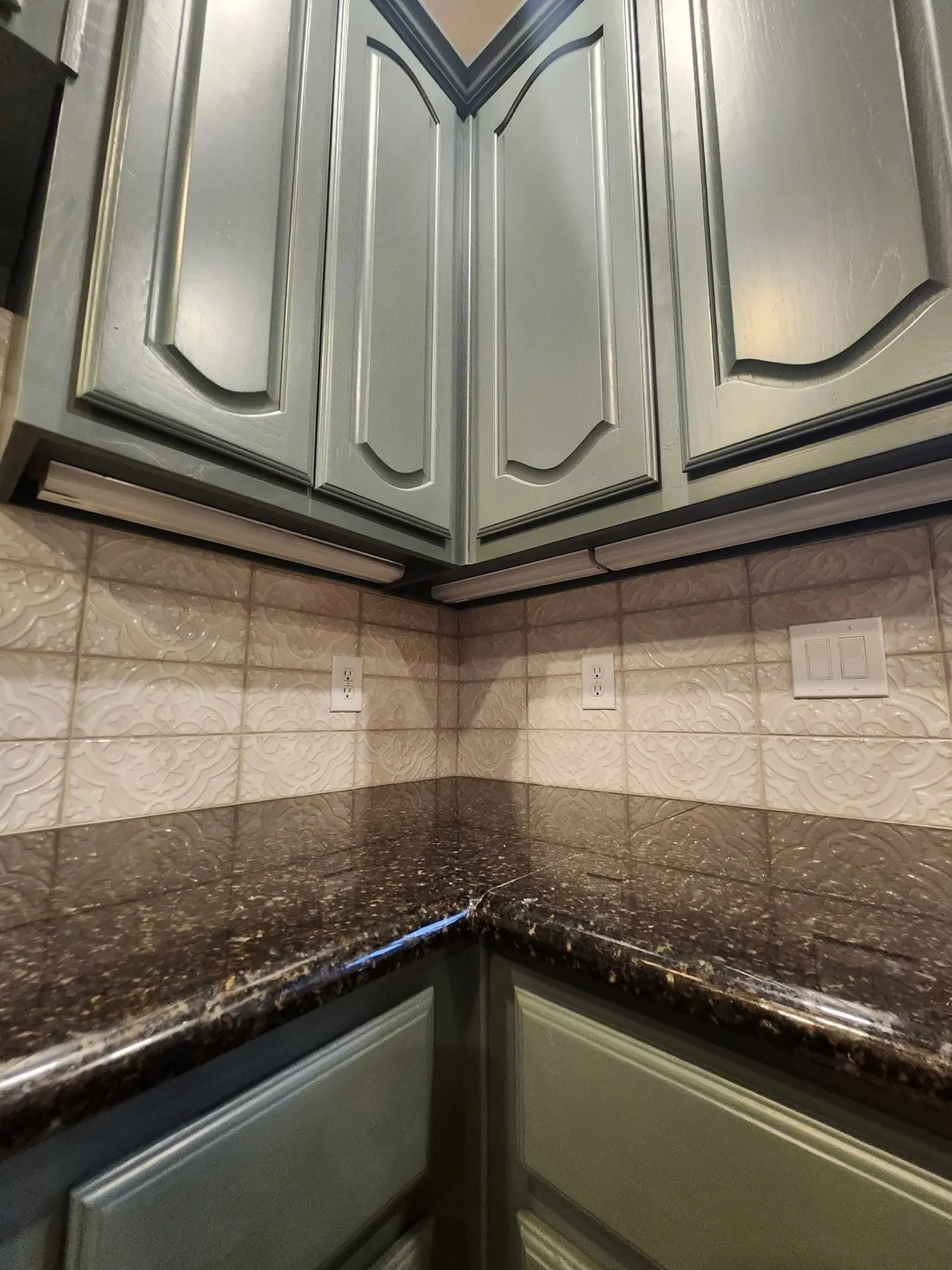 Finished green-gray cabinet corner above the counter