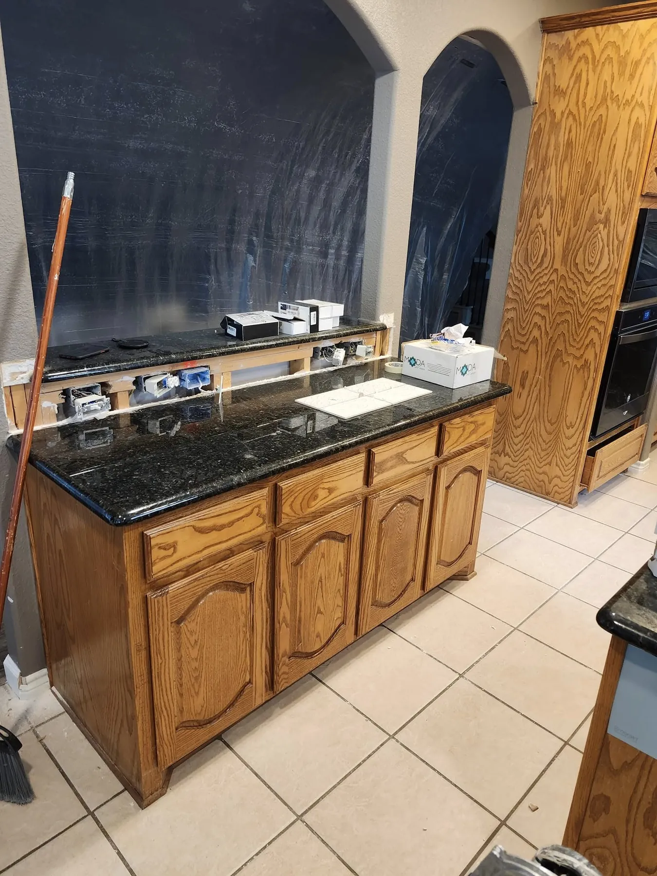 Original warm wood base cabinets and counter before painting