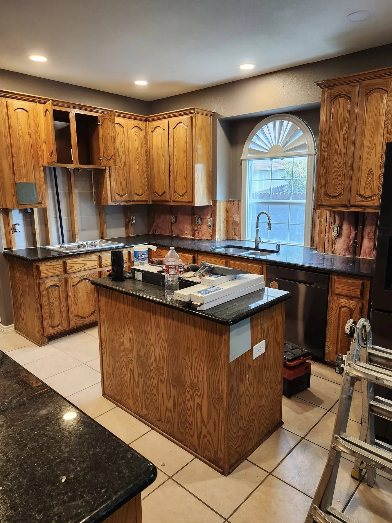 Kitchen with original warm wood cabinets and island before the color update