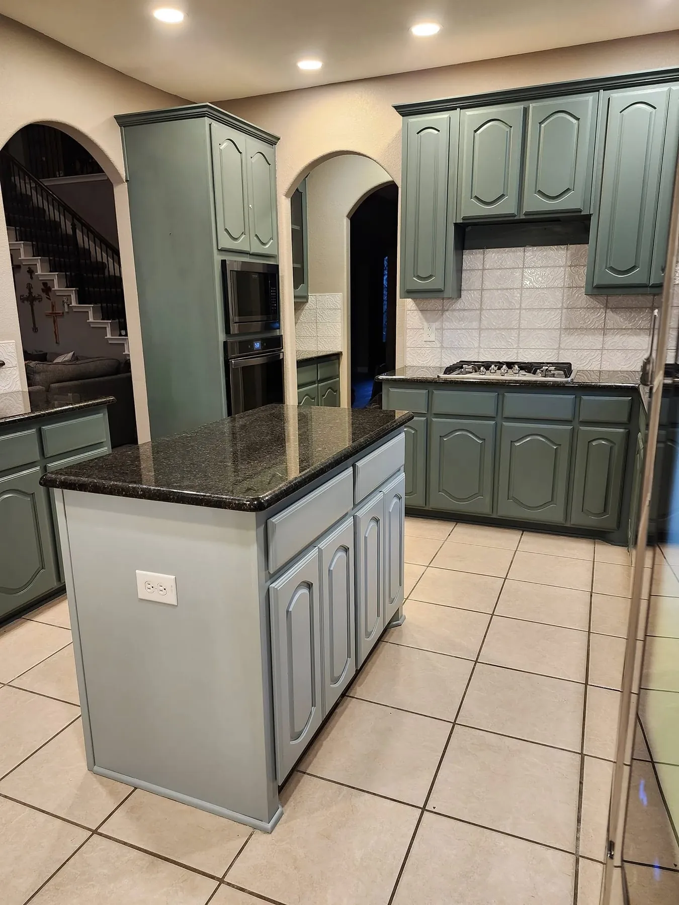 Painted island and surrounding cabinets after the color update