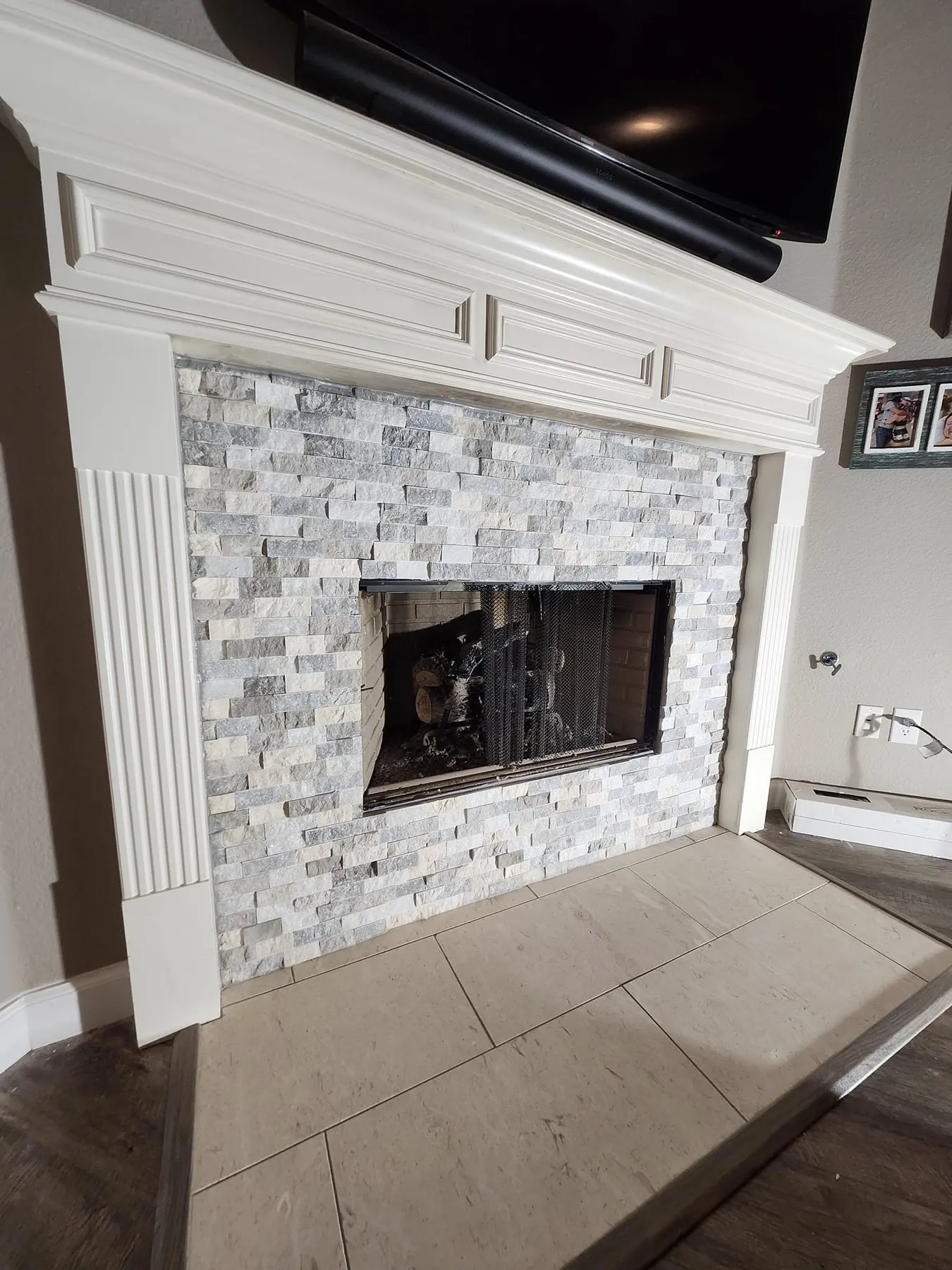 Angled view of the completed fireplace tile surround