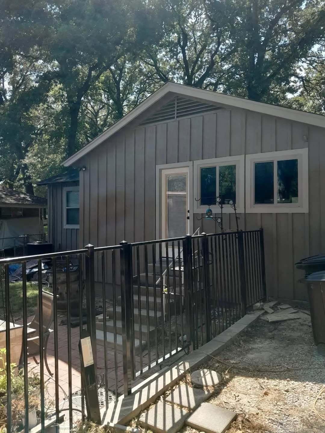 Finished gray rear elevation and light trim of the cottage