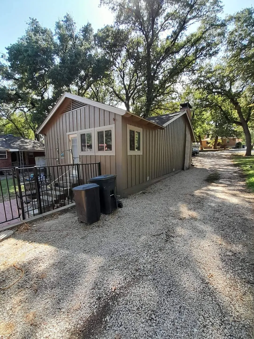 Wide completed gray side and rear exterior of the cottage