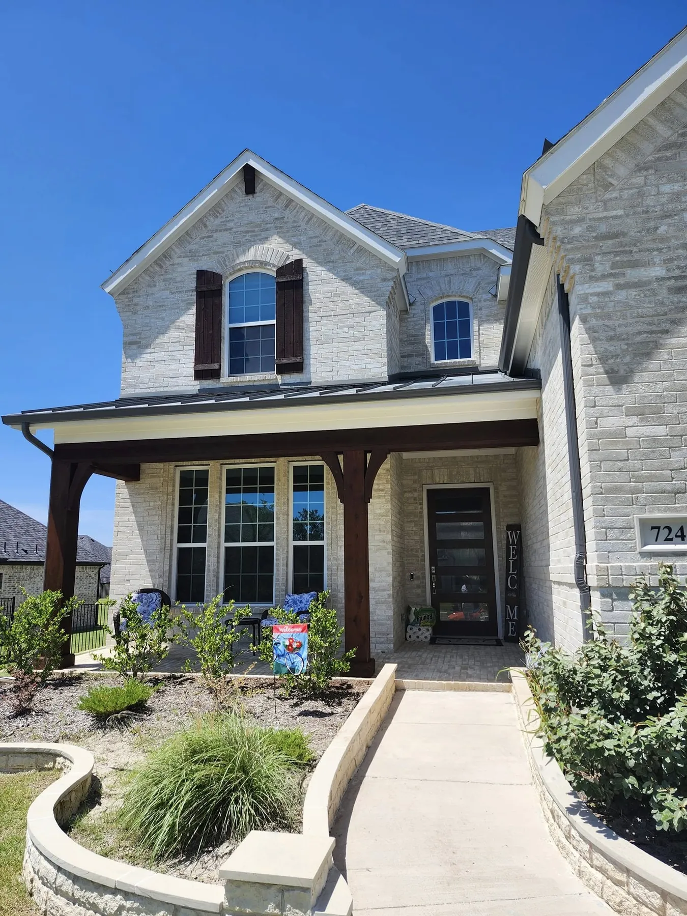 Front exterior of the limestone home and garage-door setting