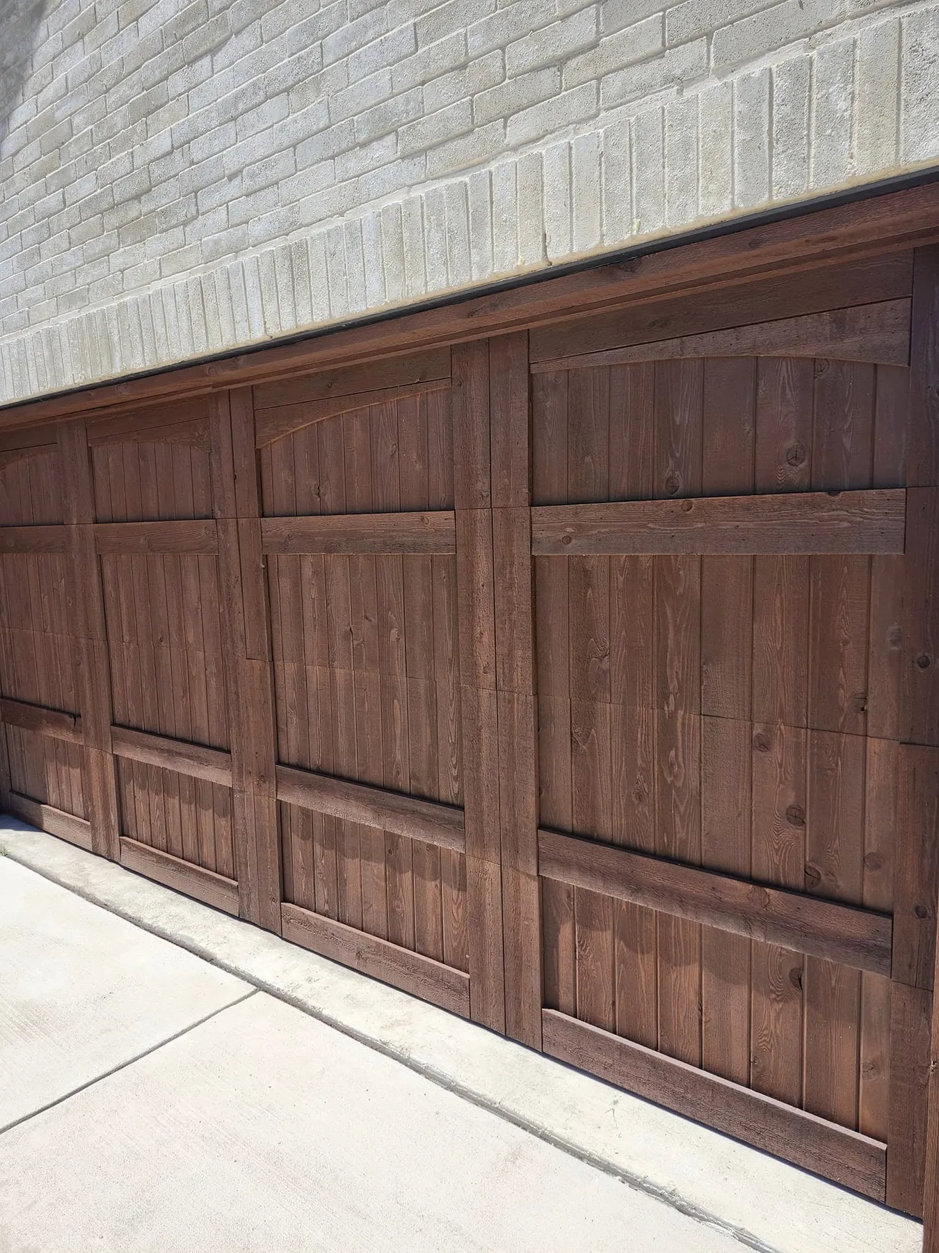 Angled close view across both finished garage doors