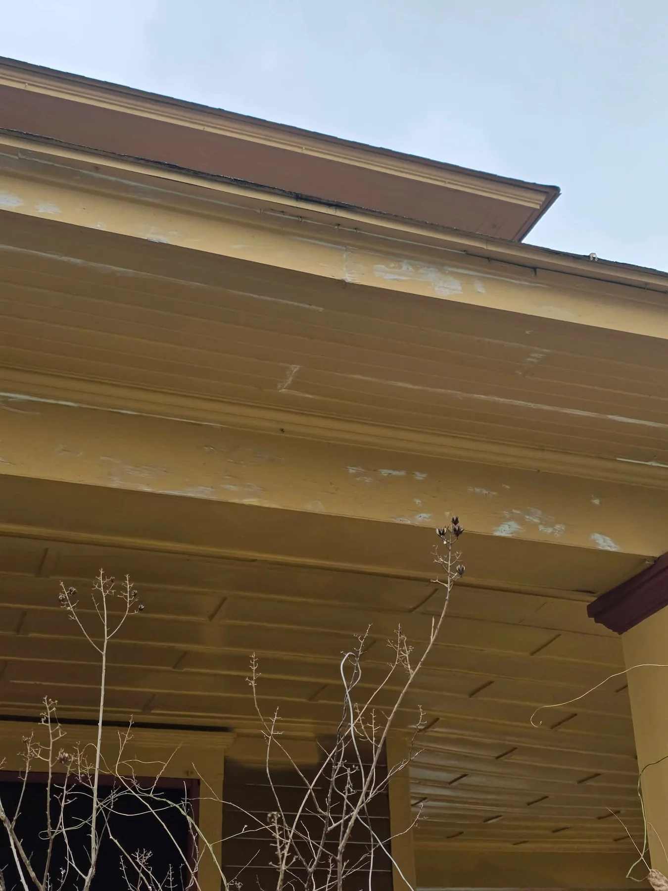 Porch ceiling and eaves during scraping and surface preparation