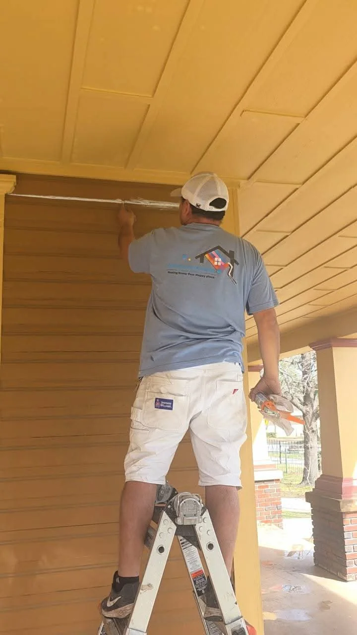 Porch wall and trim being caulked before painting