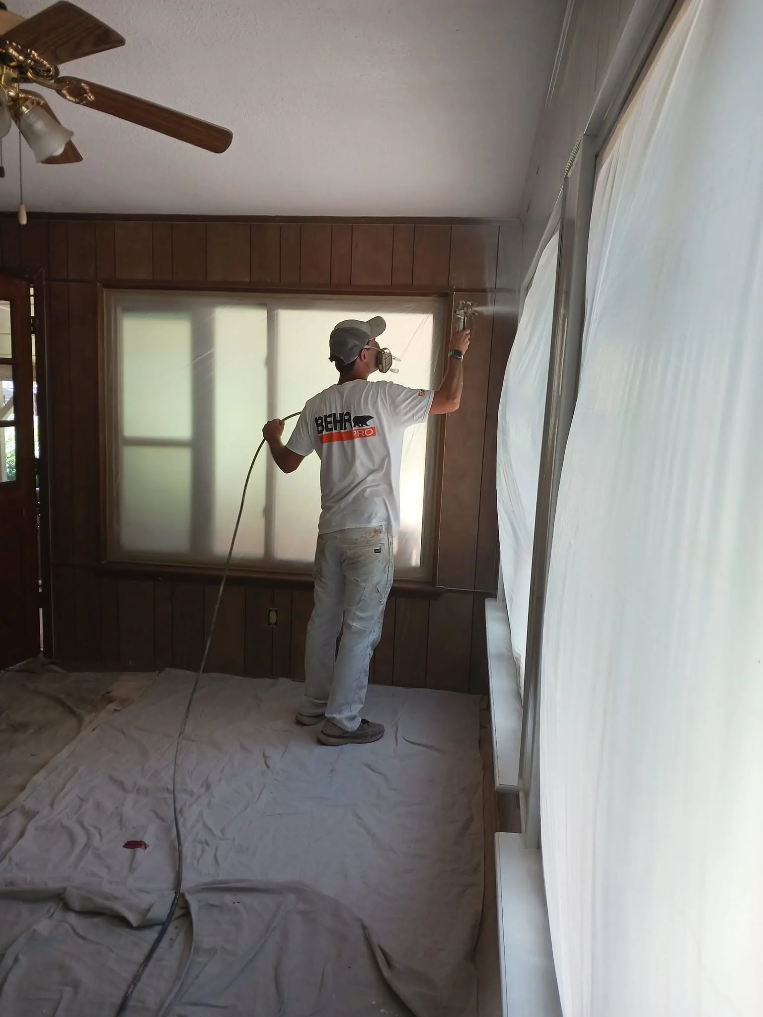 Daltonn's crew member painting an interior wall in a residential room