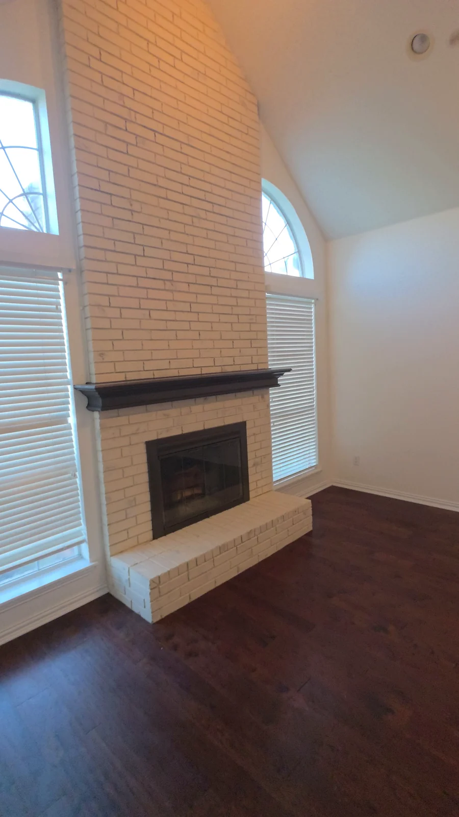Painted brick fireplace and dark mantel after the Terrell interior refresh