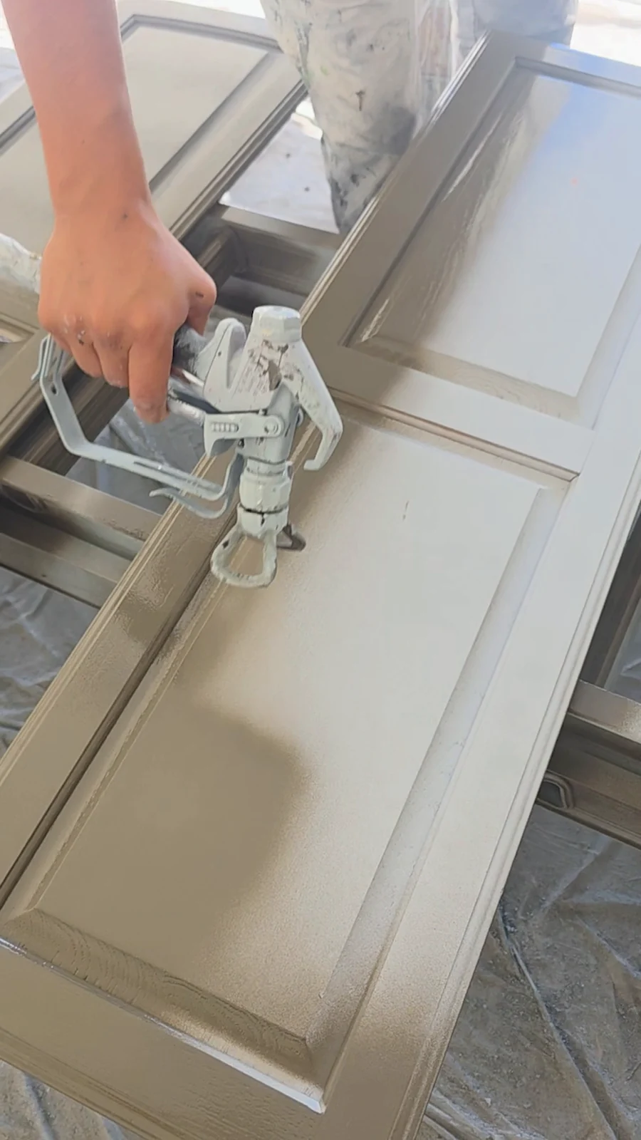 Cabinet doors being sprayed during the Terrell interior refresh