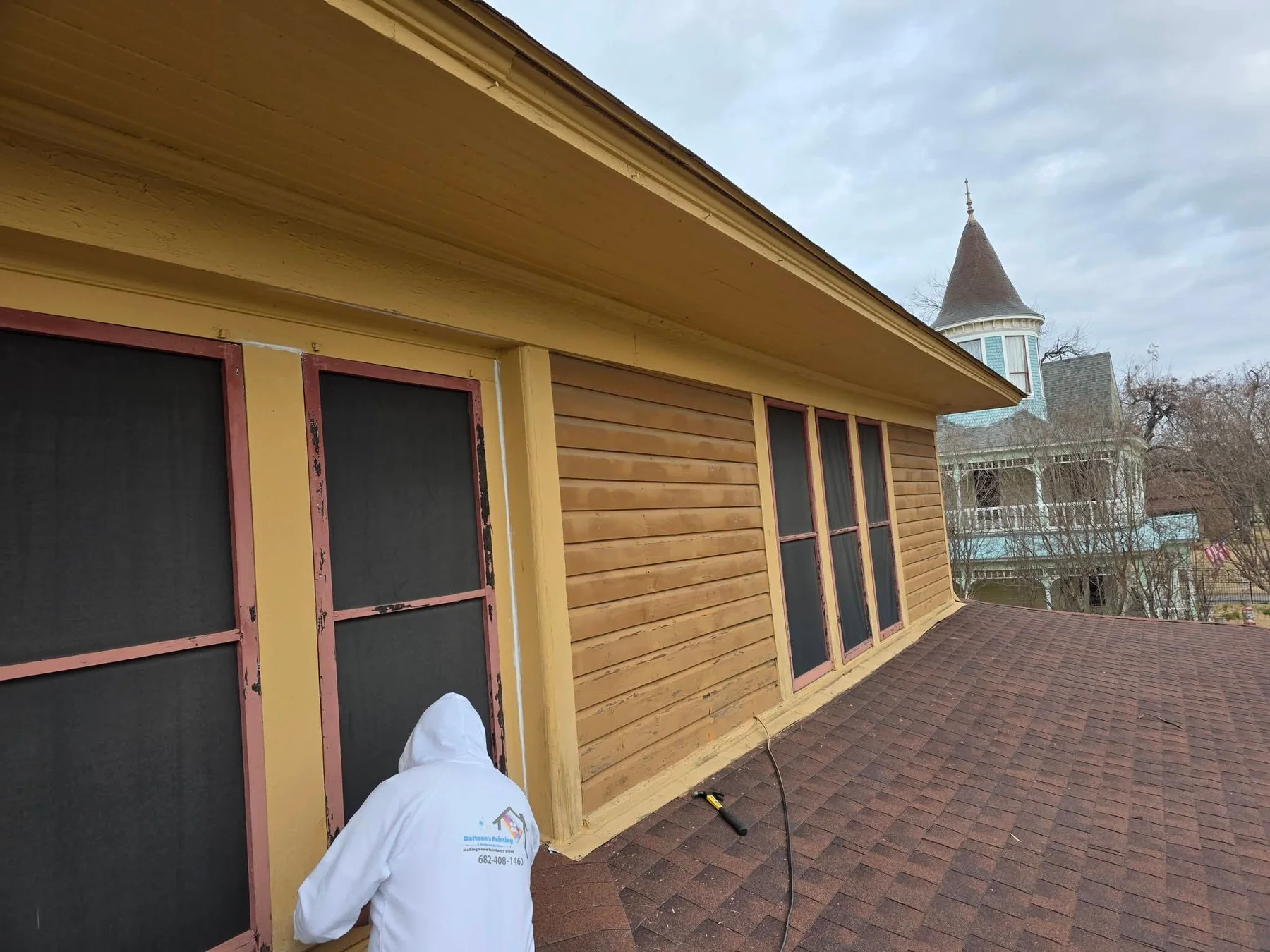 Upper exterior windows and siding during preparation work